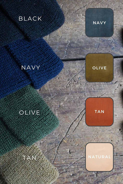 Wool hats laying on a wooden table, there are 4 colors, black, navy, olive and tan. There are swatches to the right side showing the patch colors of navy, olive, tan and natural.